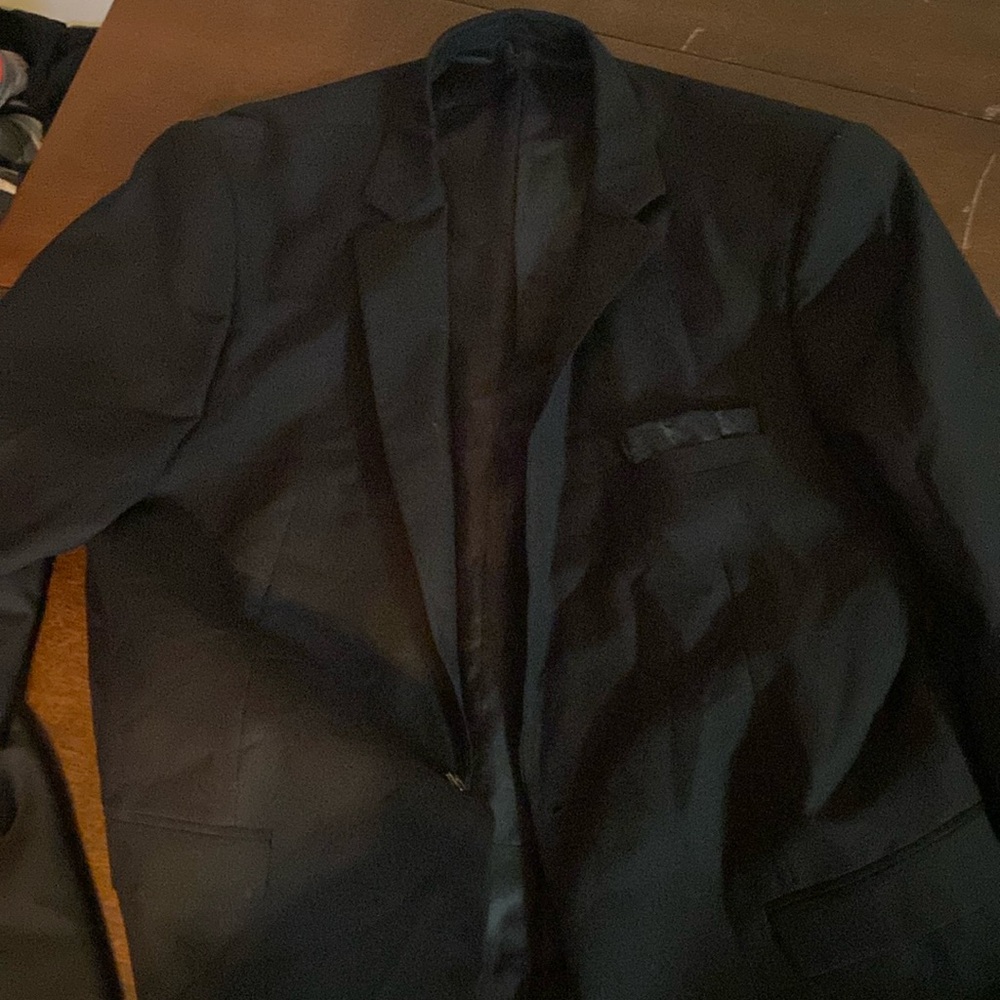 Black suit top with handkerchief.